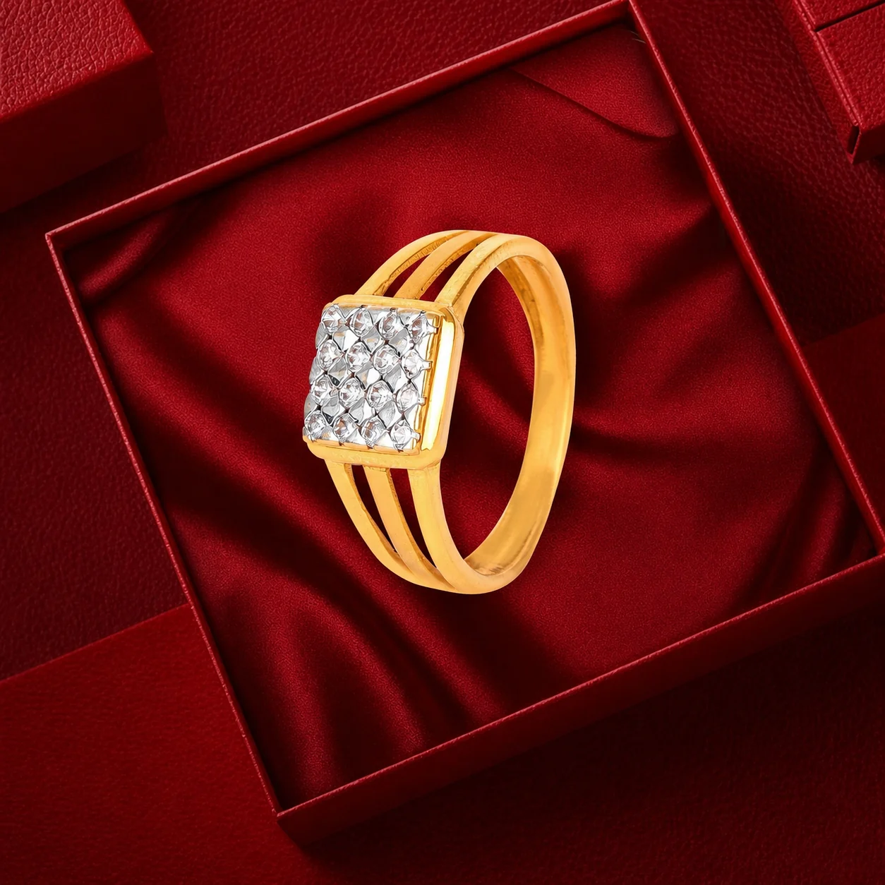 Gold ring with a square cut stone in a maroon presentation box